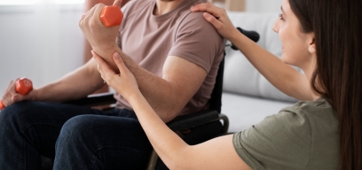 Caregivers practicing hands-on mobility and transfer techniques with therapists